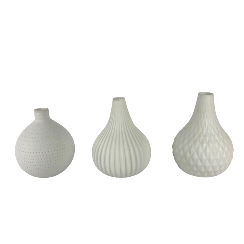 Assorted white vases without flowers.