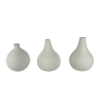 Assorted white vases without flowers.